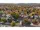 Overhead view of the home in a neighborhood featuring mature trees and foliage, with mountains visible in the distance at 7911 Raleigh Pl, Westminster, CO 80030