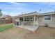 Cozy covered back patio with dining set, grill, and access to the backyard, perfect for outdoor entertaining at 7911 Raleigh Pl, Westminster, CO 80030