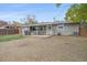 Spacious backyard featuring a covered patio, a well-maintained lawn, and a charming fence that surrounds the property at 7911 Raleigh Pl, Westminster, CO 80030