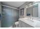 Bathroom featuring a marble countertop, a shower with glass doors, and modern fixtures at 7911 Raleigh Pl, Westminster, CO 80030
