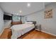 Cozy bedroom featuring hardwood floors, a large window, and neutral tones at 7911 Raleigh Pl, Westminster, CO 80030