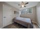 Minimalist bedroom with a comfy bed, wood-look floors and ample natural light at 7911 Raleigh Pl, Westminster, CO 80030