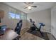 Versatile room featuring a desk, chair, Peloton bike and three large windows at 7911 Raleigh Pl, Westminster, CO 80030
