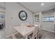 Bright dining area featuring a white wood table, six chairs, and modern decor at 7911 Raleigh Pl, Westminster, CO 80030