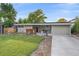 Charming one-story home boasts a well-manicured lawn and inviting front porch with seating at 7911 Raleigh Pl, Westminster, CO 80030