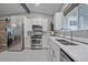 Well-lit kitchen with stainless steel appliances, white cabinets and quartz countertops at 7911 Raleigh Pl, Westminster, CO 80030