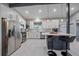 Modern kitchen featuring stainless steel appliances, white cabinetry and a breakfast bar at 7911 Raleigh Pl, Westminster, CO 80030