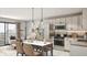 An open-concept kitchen and dining area features stainless steel appliances and modern lighting at 433 N Havana # 308, Aurora, CO 80010