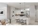 An open kitchen features a large island with barstool seating, sleek white cabinets, and stainless steel appliances at 433 N Havana # 308, Aurora, CO 80010