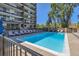 Outdoor community swimming pool with lounge chairs and balcony views at 955 Eudora St # 1107, Denver, CO 80220
