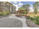 Community patio area with seating and pergolas near apartment buildings at 955 Eudora St # 1107, Denver, CO 80220