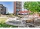 Red pergola near apartment buildings with benches and beautiful green space at 955 Eudora St # 1107, Denver, CO 80220