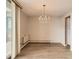 Dining area featuring wood floors, a contemporary chandelier, and natural light from a sliding door to the balcony at 955 Eudora St # 1107, Denver, CO 80220