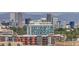 Stunning view of city skyline from multi-story building with colorful facade, trees, and mountain backdrop at 955 Eudora St # 1107, Denver, CO 80220