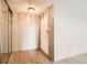 Hallway with wood floors, mirrored closet doors, and neutral walls, offering a clean and simple design at 955 Eudora St # 1107, Denver, CO 80220