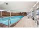 Bright indoor swimming pool with lounge chairs, brick walls, and ample natural light at 955 Eudora St # 1107, Denver, CO 80220