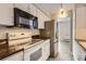 Kitchen featuring white appliances, white cabinets and dark countertops at 955 Eudora St # 1107, Denver, CO 80220