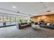 A spacious lobby with gray couches and lots of greenery is inviting and bright at 955 Eudora St # 1107, Denver, CO 80220