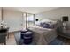 Luxurious bedroom featuring a decorative headboard, stylish furniture, and sliding glass doors to a private balcony at 955 Eudora St # 1107, Denver, CO 80220