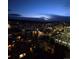 Night view of a neighborhood with city lights and mountains in the distance from a high vantage point at 955 Eudora St # 1107, Denver, CO 80220