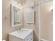 Clean bathroom with vanity, mirror, and white cabinets at 10150 E Virginia Ave # 6-305, Denver, CO 80247