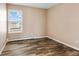 Bright bedroom with large window and wood-look floors at 10150 E Virginia Ave # 6-305, Denver, CO 80247