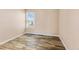 Simple bedroom with wood-look floors and window at 10150 E Virginia Ave # 6-305, Denver, CO 80247