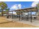 Outdoor picnic area with tables, grills, and shade structure at 10150 E Virginia Ave # 6-305, Denver, CO 80247