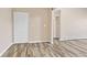 Light and bright hallway with wood-look floors and mirrored closet doors at 10150 E Virginia Ave # 6-305, Denver, CO 80247