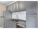 Gray cabinets, granite countertops, and stainless steel appliances at 10150 E Virginia Ave # 6-305, Denver, CO 80247