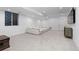 Spacious finished basement with plush carpeting and comfortable sectional sofa at 3646 Quivas St, Denver, CO 80211