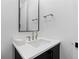 Modern half-bathroom with a floating vanity, elegant faucet, and simple mirror at 3646 Quivas St, Denver, CO 80211