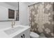 Chic bathroom with modern vanity, stylish mirror, and elegant shower curtain at 3646 Quivas St, Denver, CO 80211