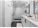 Stylish bathroom with a double sink vanity, and a glass-enclosed shower with gold hardware at 3646 Quivas St, Denver, CO 80211