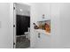 Tasteful bathroom with a shower featuring dark fixtures and built-in storage at 3646 Quivas St, Denver, CO 80211