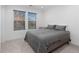 Bright bedroom featuring two windows offering natural light and a comfortable, stylish bed at 3646 Quivas St, Denver, CO 80211
