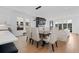Open concept dining area with modern light fixture, a large table, and lots of natural light at 3646 Quivas St, Denver, CO 80211
