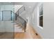 Hallway featuring clean lines, hardwood flooring, staircase with metal railing, and plenty of natural light at 3646 Quivas St, Denver, CO 80211