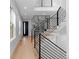 Bright foyer with modern black railing staircase and glass enclosed office area, great for working remotely at 3646 Quivas St, Denver, CO 80211