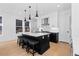 Contemporary kitchen featuring an island with breakfast bar and modern pendant lighting at 3646 Quivas St, Denver, CO 80211