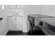 Efficient laundry area with stylish cabinets, sink, and advanced washer and dryer at 3646 Quivas St, Denver, CO 80211