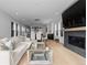 Bright, open-concept living area flows into the dining room, with hardwood floors and a fireplace at 3646 Quivas St, Denver, CO 80211