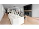 Open concept living room features a modern fireplace, tv and flows into the kitchen at 3646 Quivas St, Denver, CO 80211
