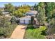 Aerial view of a beautiful house with lush landscaping, spacious driveway, and two-car garage at 3150 Lane Ct, Boulder, CO 80305