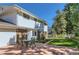 Home's backyard features a patio, grassy yard, and a mix of brick and white siding on the home at 3150 Lane Ct, Boulder, CO 80305