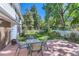 Landscaped backyard with a patio, outdoor seating, and a white picket fence at 3150 Lane Ct, Boulder, CO 80305
