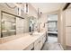 Bathroom with double sink vanity, stylish lighting, and a view into an adjacent bedroom at 3150 Lane Ct, Boulder, CO 80305
