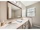 Bathroom with a vanity, a large mirror, and a window with coverings for privacy at 3150 Lane Ct, Boulder, CO 80305
