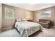 Cozy bedroom with natural light, neutral walls and a comfortable floral-patterned comforter at 3150 Lane Ct, Boulder, CO 80305