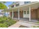 Charming brick home features a covered front porch with white columns and double front doors at 3150 Lane Ct, Boulder, CO 80305